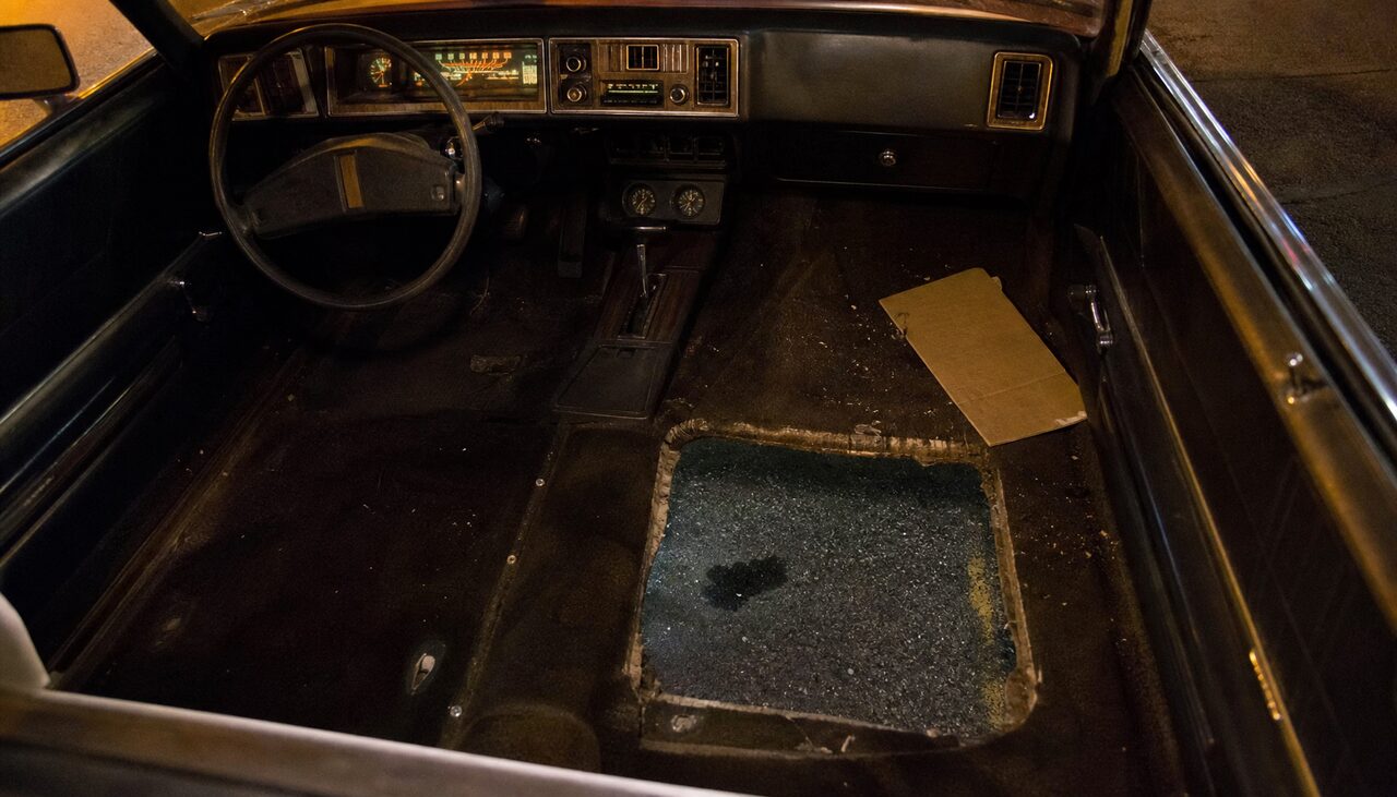 The reconstructed method: a sedan, a removed seat, and a rectangle of road below.